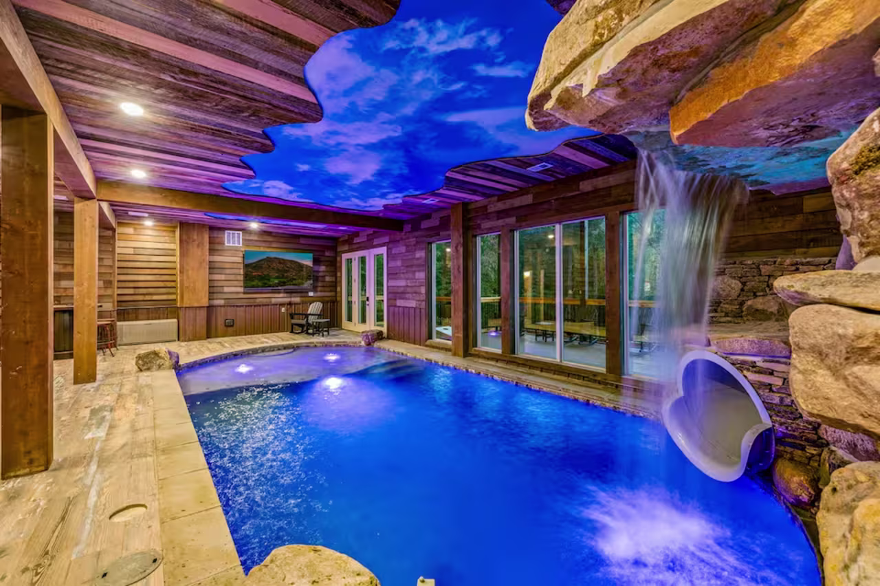large indoor pool with blue water and slide
